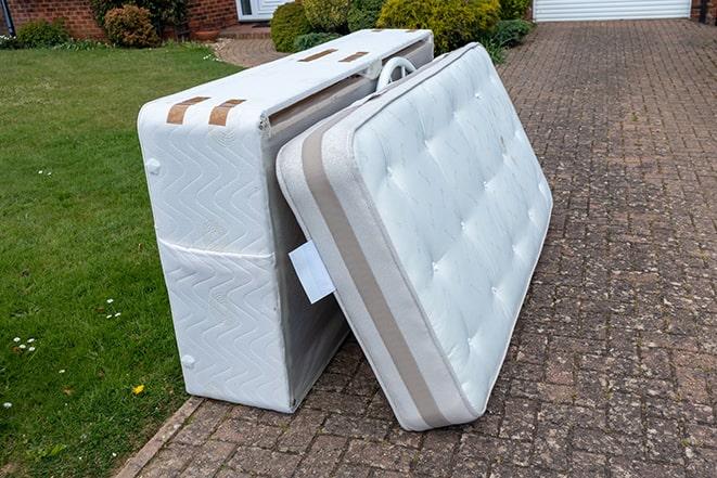 taking away a worn-out mattress